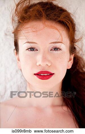 Stock Image - Young woman with red lipstick. Fotosearch