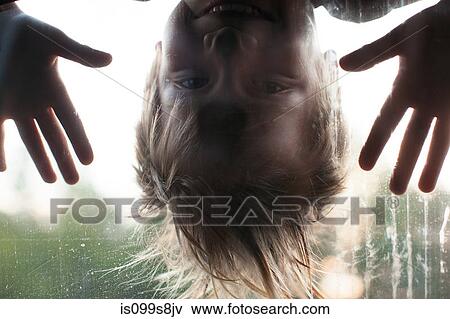 Boy looking through window, upside down View Large Photo Image Stock Photo - Boy looking through window, upside down. Fotosearch