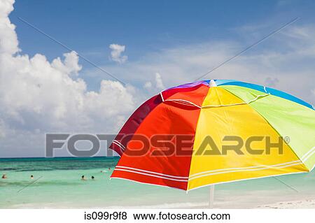 Stock Photo - Bright beach umbrella on Playa Del Carmen, Quintana Roo, Mexico. Fotosearch