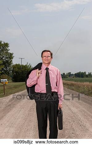 Businessman on country road View Large Photo Image Stock Photo - Businessman on country road. Fotosearch