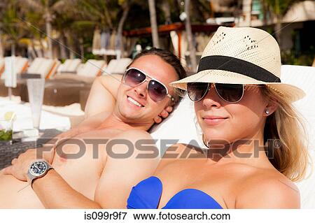 Stock Photo - Couple sunbathing at Playa Del Carmen, Quintana Roo, Mexico. Fotosearch