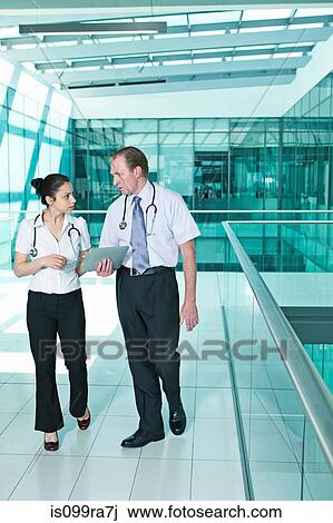 Doctors with medical records on digital tablet View Large Photo Image Stock Image - Doctors with medical records on digital tablet. Fotosearch