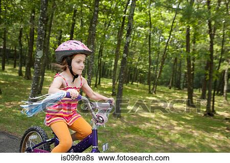 Stock Photograph - Girl cycling. Fotosearch