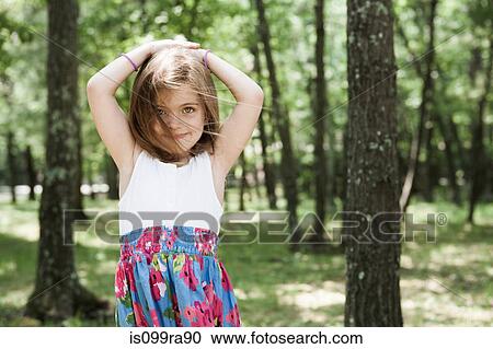 Girl in forest, hand in hair View Large Photo Image Stock Image - Girl in forest, hand in hair. Fotosearch