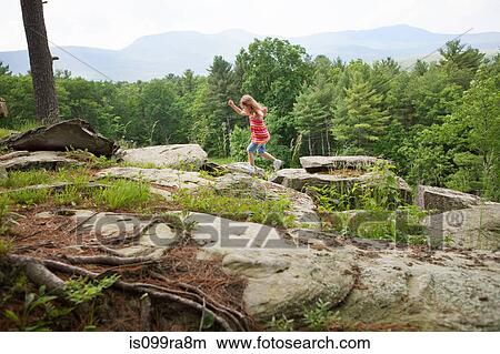 Girl playing on rocks View Large Photo Image Picture - Girl playing on rocks. Fotosearch