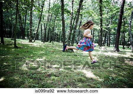 Stock Image - Girl running in forest. Fotosearch