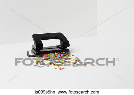 Hole puncher with multi coloured paper View Large Photo Image Picture - Hole puncher with multi coloured paper. Fotosearch