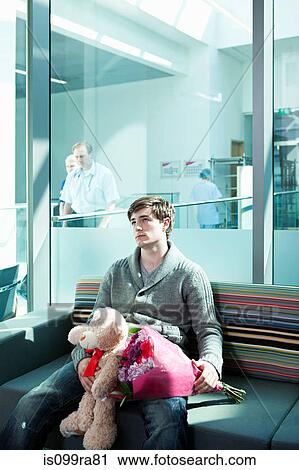 Man in hospital waiting room with bouquet and teddy bear View Large Photo Image Stock Image - Man in hospital waiting room with bouquet and teddy bear. Fotosearch