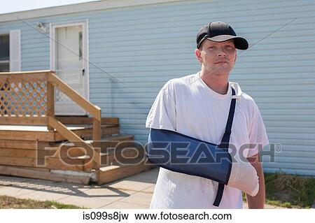 Man outside house with arm in sling View Large Photo Image Stock Photo - Man outside house with arm in sling. Fotosearch