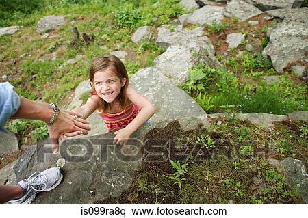 Mother helping daughter climb rocks View Large Photo Image Stock Photography - Mother helping daughter climb rocks. Fotosearch