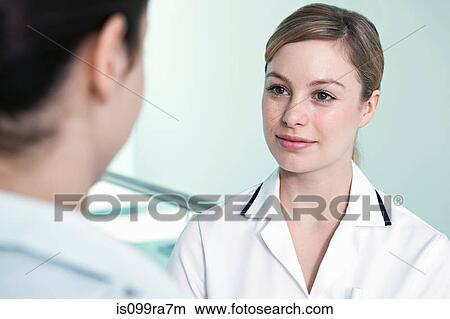 Nurse listening to colleague View Large Photo Image Picture - Nurse listening to colleague. Fotosearch