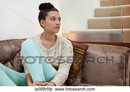 Pensive young woman on sofa View Large Photo Image Stock Photography - Pensive young woman on sofa. Fotosearch