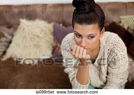 Pensive young woman with hand on chin View Large Photo Image Stock Photograph - Pensive young woman with hand on chin. Fotosearch