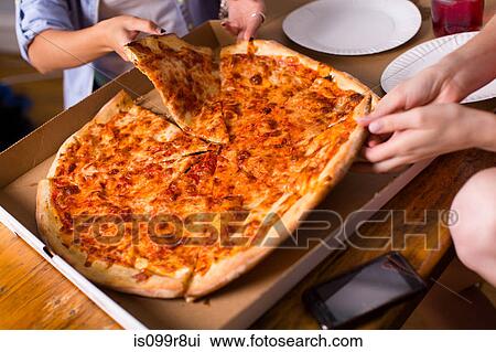 People sharing takeaway pizza View Large Photo Image Stock Image - People sharing takeaway pizza. Fotosearch
