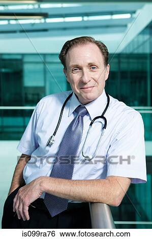 Portrait of doctor leaning on railing View Large Photo Image Stock Photograph - Portrait of doctor leaning on railing. Fotosearch