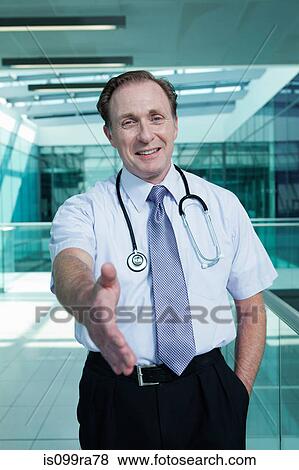 Portrait of doctor shaking hands, personal perspective View Large Photo Image Stock Photo - Portrait of doctor shaking hands, personal perspective. Fotosearch
