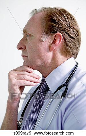 Portrait of doctor with hand on chin View Large Photo Image Stock Photo - Portrait of doctor with hand on chin. Fotosearch