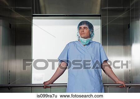 Stock Photograph - Portrait of surgeon in hospital elevator. Fotosearch