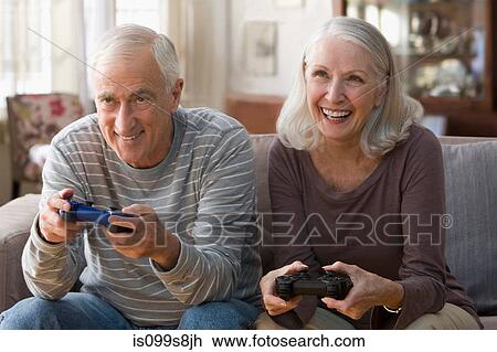 Stock Image - Senior couple playing video game. Fotosearch