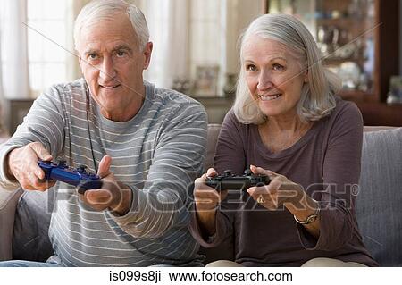 Stock Image - Senior couple playing video game. Fotosearch