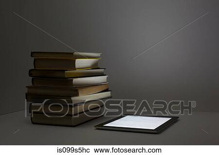Stack of books with digital tablet View Large Photo Image Stock Image - Stack of books with digital tablet. Fotosearch