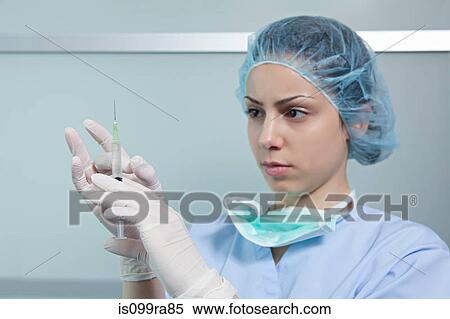 Stock Photography - Surgeon holding injection. Fotosearch