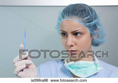 Stock Photograph - Surgeon holding scalpel. Fotosearch