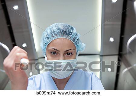 Surgeon shining torch, personal perspective View Large Photo Image Picture - Surgeon shining torch, personal perspective. Fotosearch