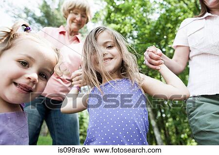 Three genration family holding hands, candid View Large Photo Image Stock Image - Three genration family holding hands, candid. Fotosearch