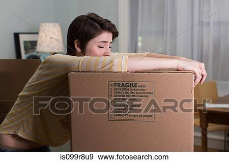 Tired young woman resting on moving box View Large Photo Image Stock Photo - Tired young woman resting on moving box. Fotosearch