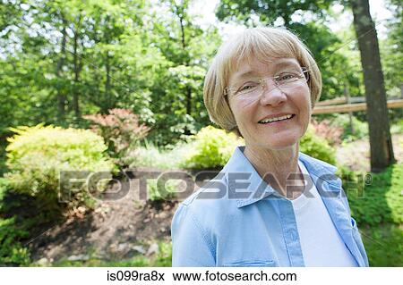 Stock Photo - Woman in garden. Fotosearch