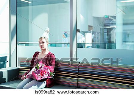 Woman in hospital waiting room with bouquet View Large Photo Image Stock Image - Woman in hospital waiting room with bouquet. Fotosearch
