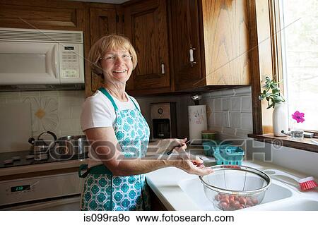 Woman preparing strawberries in kitchen View Large Photo Image Picture - Woman preparing strawberries in kitchen. Fotosearch