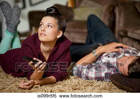 Young couple watching televsion View Large Photo Image Stock Photography - Young couple watching televsion. Fotosearch