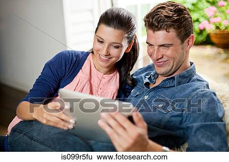 Young couple with digital tablet View Large Photo Image Stock Photograph - Young couple with digital tablet. Fotosearch