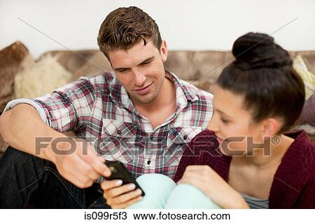 Stock Image - Young couple with smartphone. Fotosearch