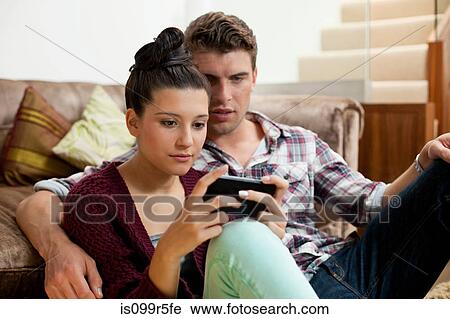 Stock Image - Young couple with smartphone. Fotosearch