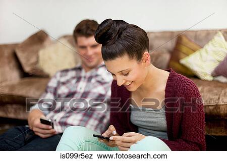 Young couple with smartphones View Large Photo Image Stock Photo - Young couple with smartphones. Fotosearch