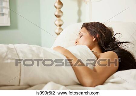 Young woman asleep in bed View Large Photo Image Stock Image - Young woman asleep in bed. Fotosearch