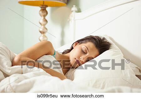 Young woman asleep in bed View Large Photo Image Stock Photograph - Young woman asleep in bed. Fotosearch