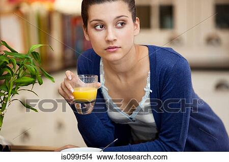 Young woman drinking orange juice View Large Photo Image Picture - Young woman drinking orange juice. Fotosearch