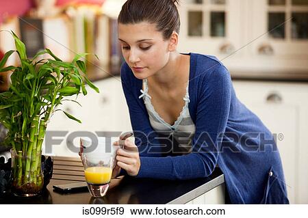 Young woman eating breakfast View Large Photo Image Stock Photo - Young woman eating breakfast. Fotosearch