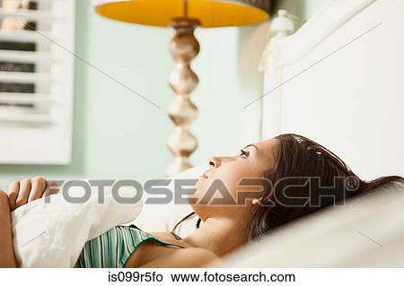 Young woman in bed daydreaming View Large Photo Image Picture - Young woman in bed daydreaming. Fotosearch