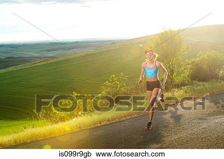 Young woman running in landscape of Palouse Hills, Washington, USA View Large Photo Image Stock Image - Young woman running in landscape of Palouse Hills, Washington, USA. Fotosearch