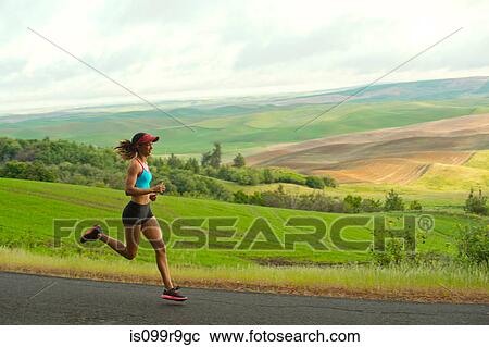 Young woman running in landscape of Palouse Hills, Washington, USA View Large Photo Image Stock Image - Young woman running in landscape of Palouse Hills, Washington, USA. Fotosearch
