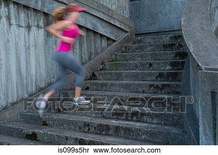Young woman running up stairs, motion blur View Large Photo Image Stock Photography - Young woman running up stairs, motion blur. Fotosearch