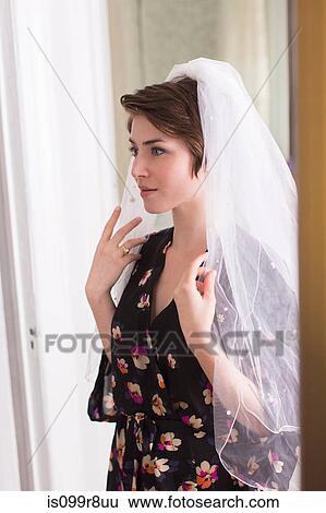 Young woman wearing a bridal veil View Large Photo Image Stock Photograph - Young woman wearing a bridal veil. Fotosearch