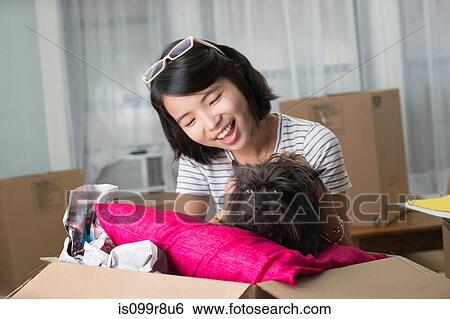Young woman with pet dog in moving box View Large Photo Image Stock Photograph - Young woman with pet dog in moving box. Fotosearch