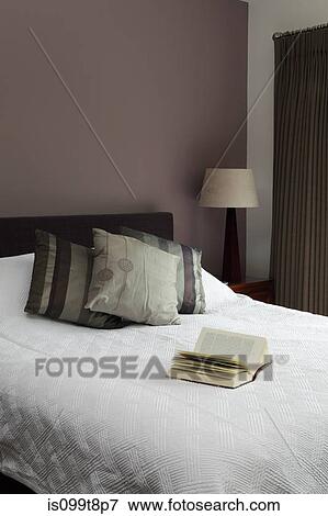Stock Photo - Book on a bed. Fotosearch