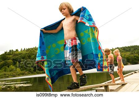 Boy on a pier with towel View Large Photo Image Stock Photography - Boy on a pier with towel. Fotosearch